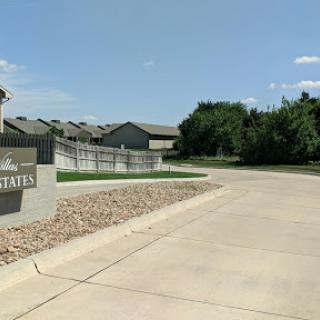 Entrance to a residential apartment complex on a sunny day.