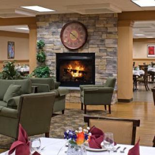 A cozy dining area featuring a stone fireplace and inviting seating.