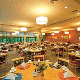 A spacious restaurant dining area with neatly set tables ready for guests.