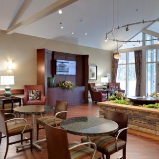 A modern and inviting lounge area featuring comfortable seating and natural lighting.