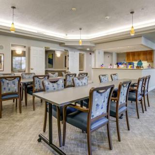 A modern dining area with neatly arranged tables and chairs.