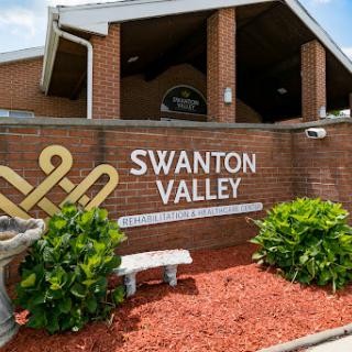 Entrance to Swanton Valley showcasing the community's name and surrounding landscaping.
