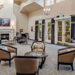 Spacious living room with elegant furniture and large windows.