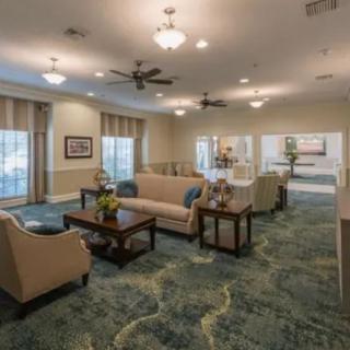 A well-lit living room with comfortable seating and elegant decor.
