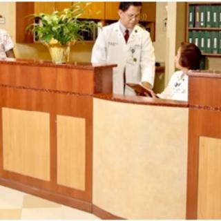 Medical staff at a hospital reception desk.