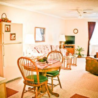Cozy living room with a dining area and various furniture pieces.