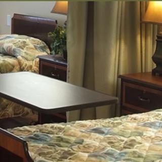 A cozy bedroom with two beds, nightstands, and lamps.