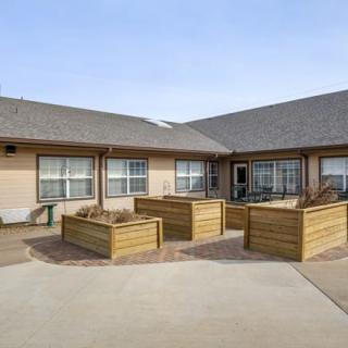 A residential courtyard featuring raised wooden planters.