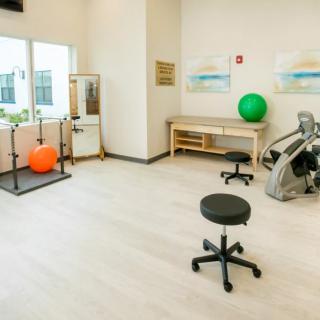 A rehabilitation room equipped with exercise equipment and therapy balls.