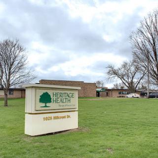 The Heritage Health facility, set against a cloudy backdrop.