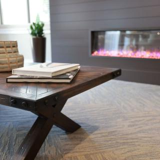 A cozy living room with a modern coffee table and fireplace.