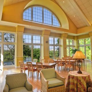 Spacious living and dining area with large windows and abundant natural light.