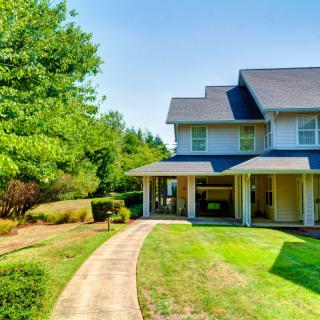A charming suburban house with a well-maintained lawn and pathway.