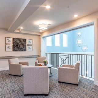 A modern lounge area with comfortable seating and contemporary artwork.