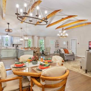 A stylish open-concept living and dining area featuring modern furniture and a sleek kitchen.