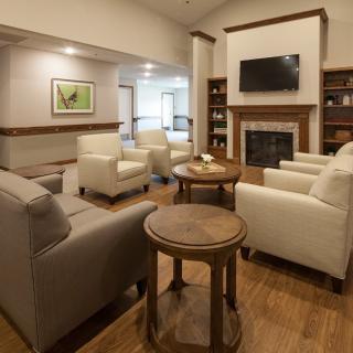 A cozy living room with comfortable seating and a fireplace.