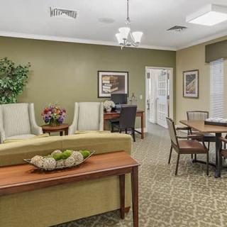 A cozy living room with seating area, table, and decorative elements.