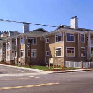 A modern apartment building located on a street corner.