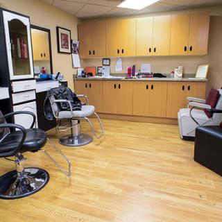 A cozy hair salon with modern barber chairs and mirrors.