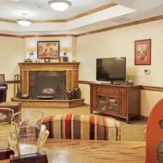 Cozy living room with a fireplace, television, and comfortable furniture.