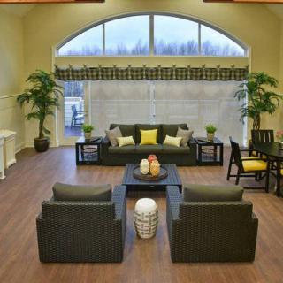 A cozy living room with stylish furniture and large windows.