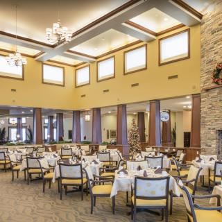 Spacious and elegant restaurant interior with neatly arranged tables and chairs.