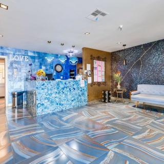 A modern lobby with a mosaic-tiled reception desk and stylish interior decor.
