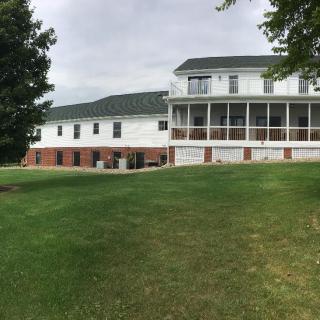 A large residential house with a spacious lawn.