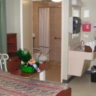 Hospital room with bed and bathroom facilities.