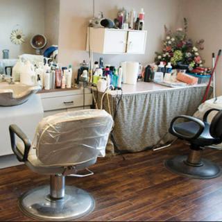 A cozy hair salon interior with styling chairs and beauty products.