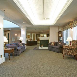 A spacious lobby with comfortable seating and soft lighting.