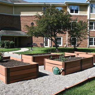 A community garden with raised beds in an urban setting.