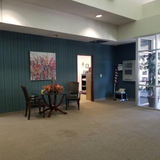A cozy waiting area featuring comfortable chairs and an artistic touch.