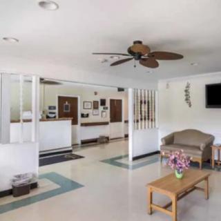 A hotel lobby with a reception desk and comfortable seating area.
