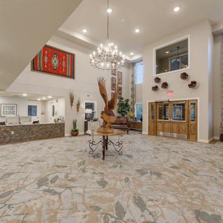 Spacious lobby area featuring modern decor with a chandelier and art pieces.
