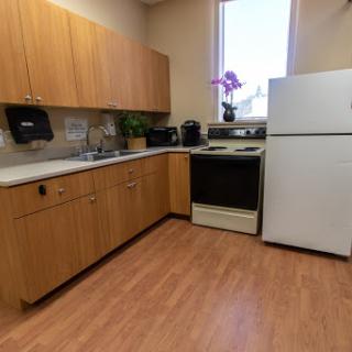 A well-equipped kitchen featuring wooden cabinets and essential appliances.