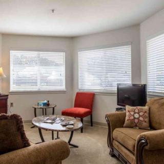 A cozy living room with comfortable seating and ample natural light.