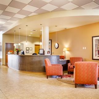 A modern lobby with comfortable seating and a reception desk.