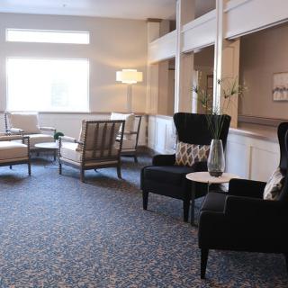 A cozy lobby seating area with comfortable chairs and a stylish lamp.
