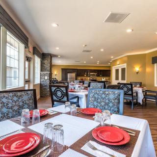 A well-decorated restaurant dining area with neatly set tables and comfortable seating.