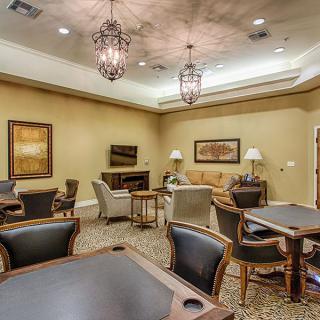 A comfortable lounge room with seating and tables.