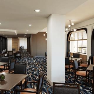 A modern dining area with neatly arranged tables and chairs.