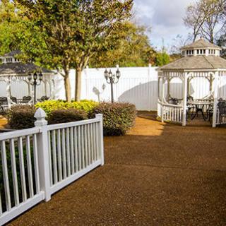 A peaceful outdoor garden featuring a charming gazebo and well-maintained landscaping.