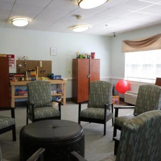 A therapy room with chairs arranged in a circle for group sessions.