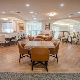 A modern lounge area with comfortable seating and wooden flooring.