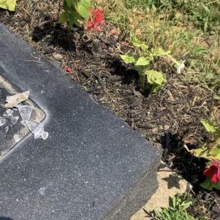 A grave adorned with fresh flowers in a cemetery.