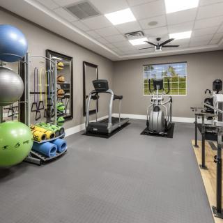 A well-equipped home gym with various exercise machines and fitness accessories.