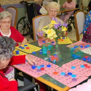 A group of elderly individuals enjoying a game of bingo at a community center.