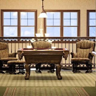 A cozy and elegantly designed room with classic furniture and soft lighting.