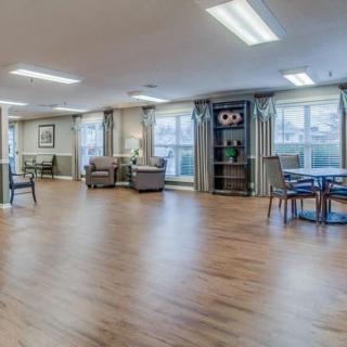 Spacious lounge area with wooden flooring and comfortable seating.